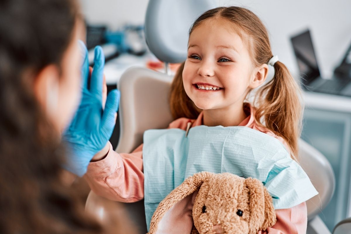 happy kid having early orthodontic checkup at west palm beach orthodontist office